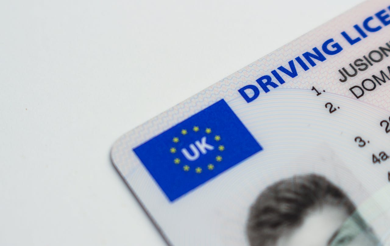 Services Detailed photo of a UK driving license showcasing EU flag and identity features.